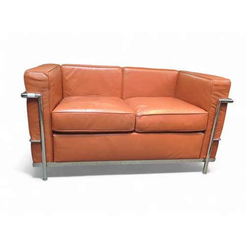 67 - Le Corbusier-style 2-seater sofa in burnt orange. W127cm D72cm H69cm.