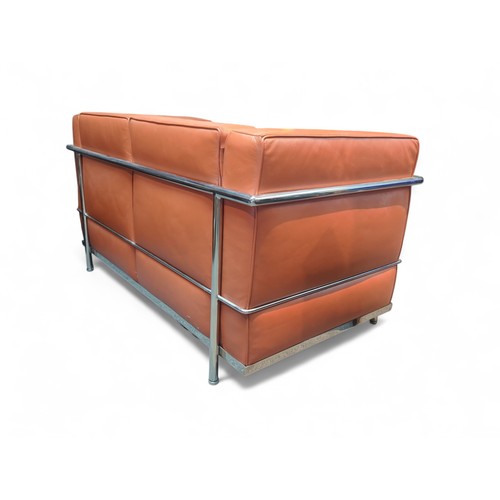 67 - Le Corbusier-style 2-seater sofa in burnt orange. W127cm D72cm H69cm.