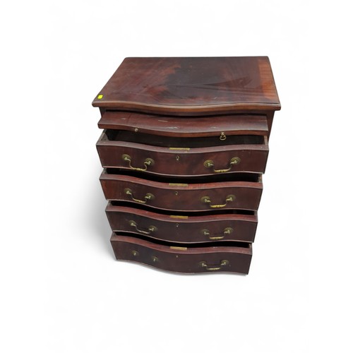 90 - Serpentine 4 drawer chest of drawers with writing shelf. W61cm D43cm H76cm.