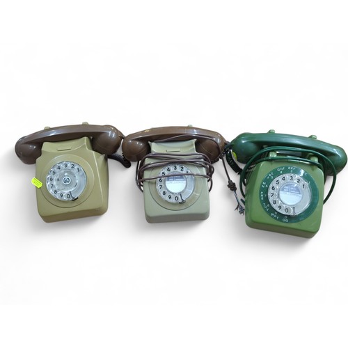 144 - 3 x rotary phones (all various shades of green). One marked P.O. to base.