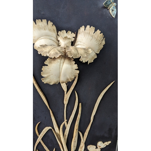 242 - Japanese carved bone on black lacquer panel depicting an iris and butterfly in a carved wooden frame... 