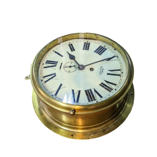 321 - Brass cased Smiths Empire bulkhead clock, white dial with Roman numerals and subsidiary seconds dial... 