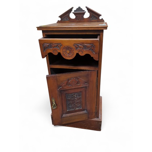 162 - A late Victorian bedside cupboard with rear gallery, carving to door front, and ceramic chamberpot. ... 