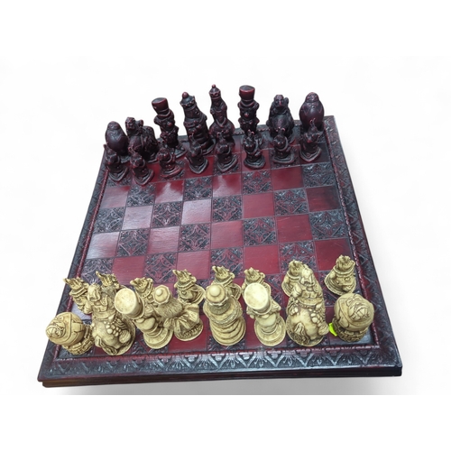 177 - Alice in Wonderland themed chess set, with a complete set of composite figures