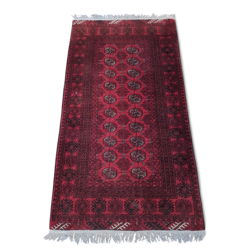 274 - Afghan red rug. 100cm by 197cm approx