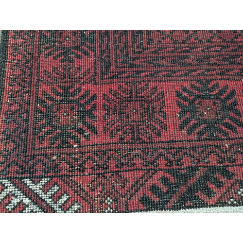 274 - Afghan red rug. 100cm by 197cm approx