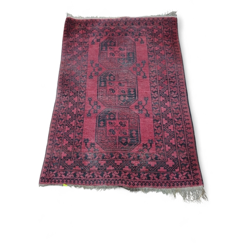 279 - Afghan red and black rug 103cm by 152cm approx