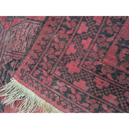 279 - Afghan red and black rug 103cm by 152cm approx