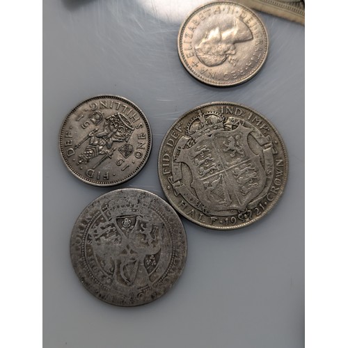 583 - Tin of assorted coins and banknotes, including some silver, gross weight including tin 700 grams