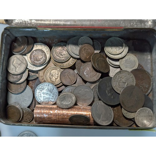 583 - Tin of assorted coins and banknotes, including some silver, gross weight including tin 700 grams