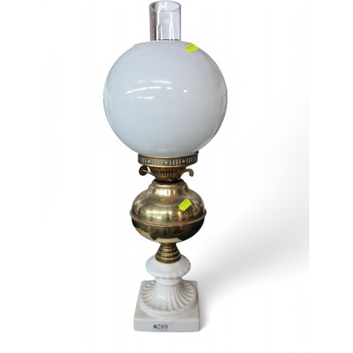 289 - Ceramic and brass oil lamp with glass flue and shade, height 56cm