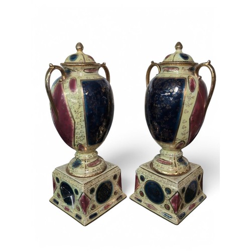 299 - Pair of A.G. Harley Jones Staffordshire Royal Vienna pottery ornate urns and covers, early 20th cent... 