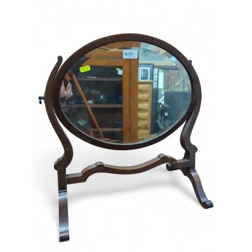 89 - Wood-framed oval dressing mirror. Small amount of inlay to mirror itself. W49cm H49cm.