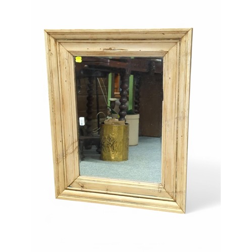 155 - Stripped pine framed bevelled mirror. W83cm H66cm