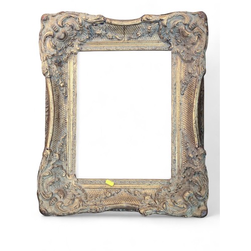 372 - Ornate gilt frame. Some areas of damage/cracking. W49cm H59cm.