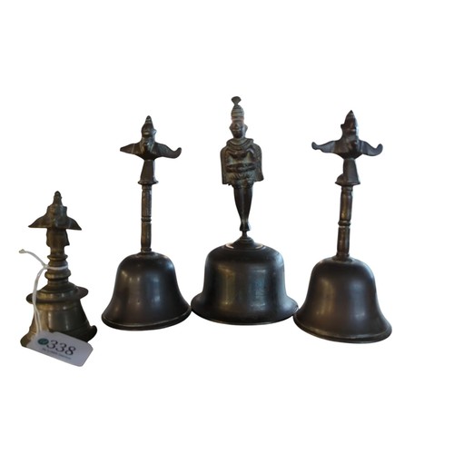 338 - Four bronze Asian hand bells with figural handles, including a pair, the largest bell engraved and w... 