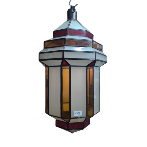 377 - Large glass lantern with coloured glass panels. H70cm.