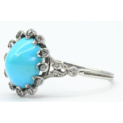 33 - Cabochon turquoise and diamond cluster ring, the white metal mount tested as platinum, size Q, gross... 