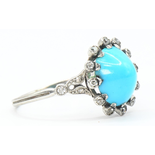 33 - Cabochon turquoise and diamond cluster ring, the white metal mount tested as platinum, size Q, gross... 