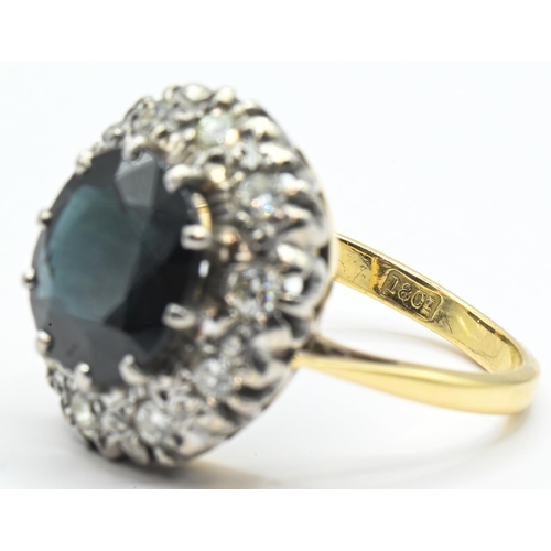 52 - Sapphire and diamond cluster ring, the yellow metal mount stamped 18CT, tested as 18ct gold, size P1... 