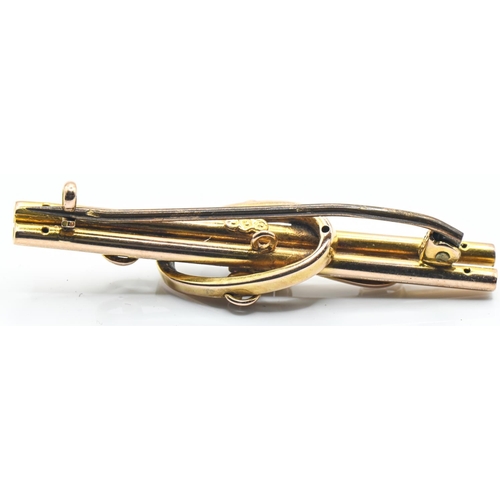 56 - Yellow metal and pink stone bar brooch, marked 9CT, tested as 9ct gold, length 42mm, with base metal... 