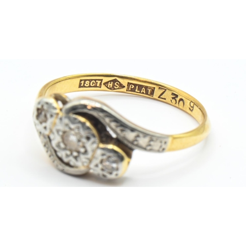 97 - Diamond three stone crossover ring, set to a polished band stamped 18CT PLAT and with maker's mark H... 