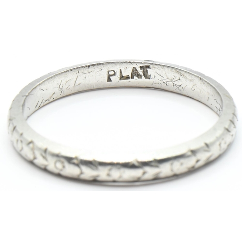 98 - Platinum band ring, with a continuous foliate design, stamped PLAT, size L1/2, 3 grams