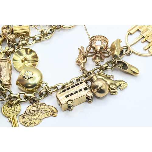 121 - 9ct gold charm bracelet with heart-shaped padlock clasp suspending various charms including hallmark... 