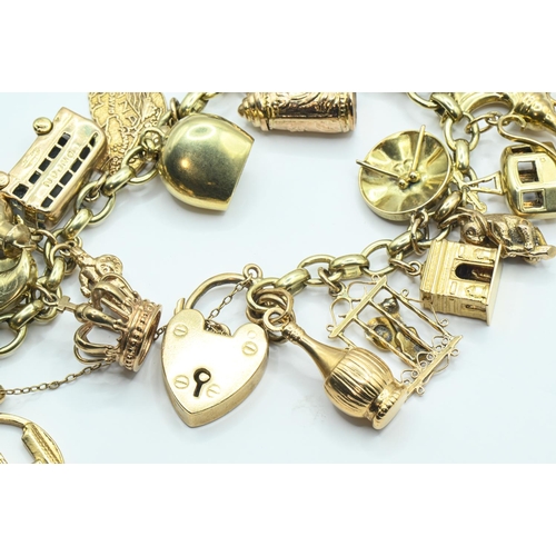 121 - 9ct gold charm bracelet with heart-shaped padlock clasp suspending various charms including hallmark... 