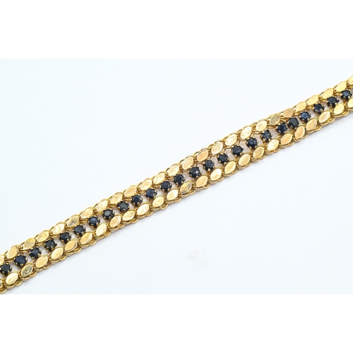 126 - High grade yellow metal and dark blue gem-set bracelet, marked 18, tested as 18ct gold, length 185mm... 