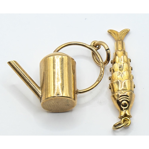 127 - Two 9ct gold hallmarked charms, including an articulated fish and a watering can, length approximate... 