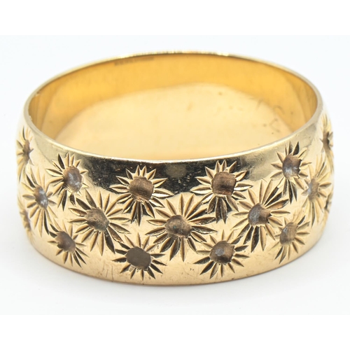 169 - 9ct gold ring, the wide band with a continuous floral pattern, hallmarked London 1978, size R, 5.2 g... 