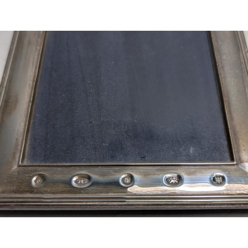 201 - Two silver photo frames, including: one of plain design hallmarked to the front Carr's of Sheffield ... 