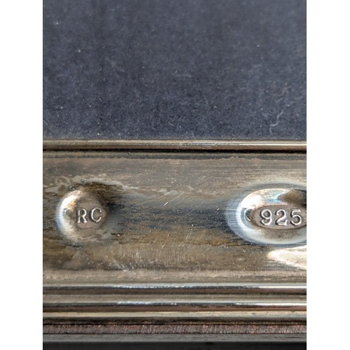 201 - Two silver photo frames, including: one of plain design hallmarked to the front Carr's of Sheffield ... 