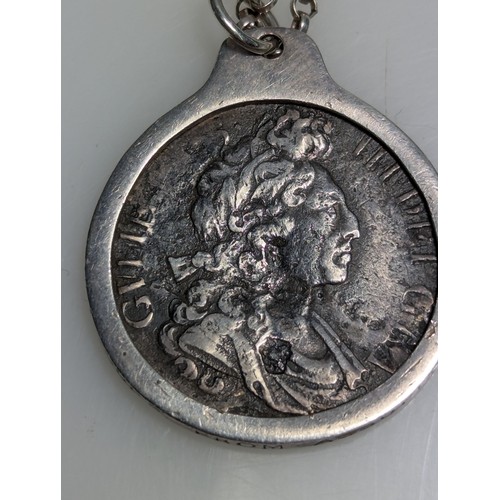 229 - William III shilling in pendant mount with chain, mount inscribed 'Treasure from Association 1707', ... 