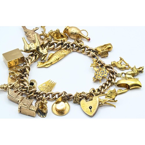 119 - Yellow metal charm bracelet with heart-shaped padlock clasp suspending 26 various 9ct gold and yello... 