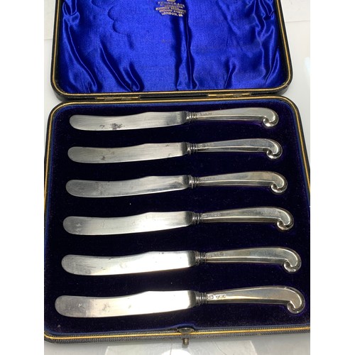 221 - Cased set of hallmarked silver handled pistol grip butter knives and a cased set of George Unite hal... 