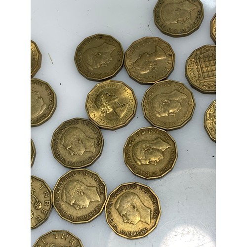 244 - Box of brass threepences gross weight including box 960 grams