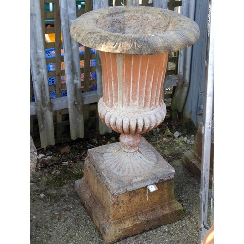 4 - Pair of concrete urns on square plinths with fluted decoration, dia. 45cm x ht. 86cm