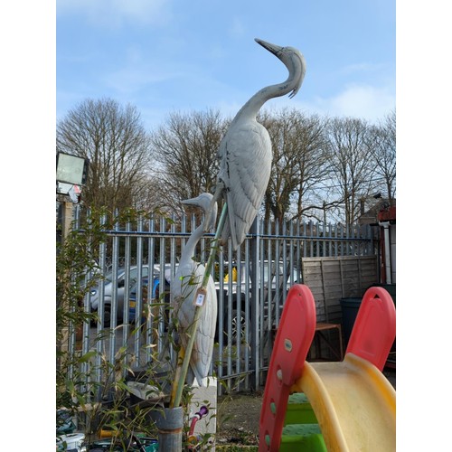 99 - Two life size plastic herons on poles