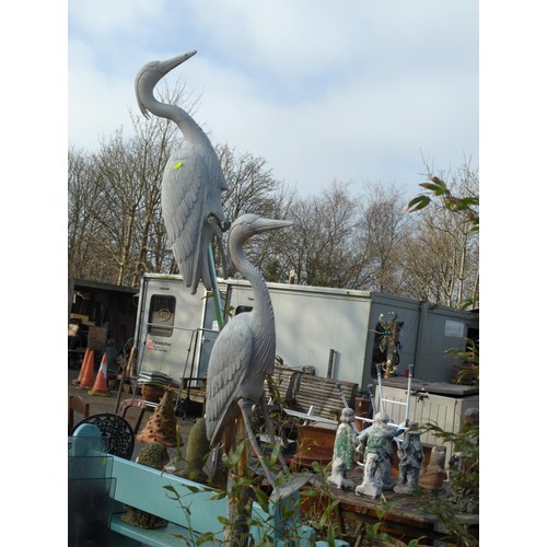 99 - Two life size plastic herons on poles