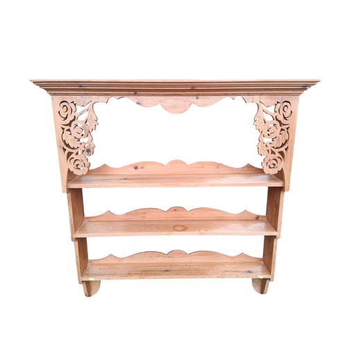 413A - Pine wall-mounted book shelf with 3 shelves and carvings to top. W114cm D26cm H120cm.