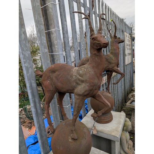 3 - Pair of cast iron stags on sphere bases, dia. 22cm x ht. 89cm approx.