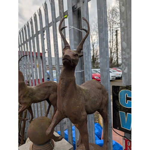 3 - Pair of cast iron stags on sphere bases, dia. 22cm x ht. 89cm approx.