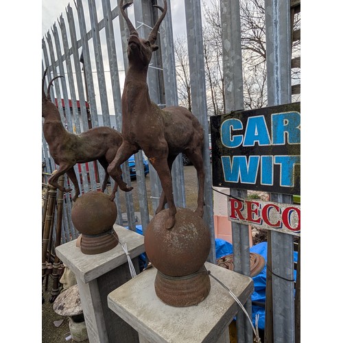 3 - Pair of cast iron stags on sphere bases, dia. 22cm x ht. 89cm approx.