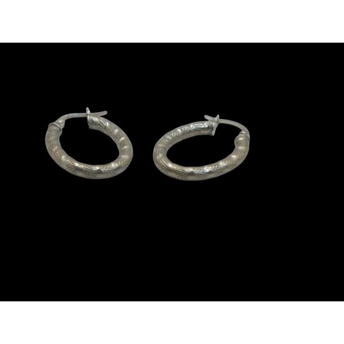 42 - Pair of Italian 9ct gold oval textured hoop earrings, stamped 375 and 1238AR, length 23mm, gross wei... 