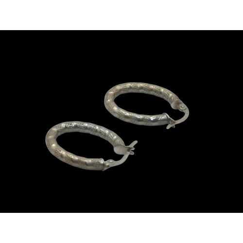 42 - Pair of Italian 9ct gold oval textured hoop earrings, stamped 375 and 1238AR, length 23mm, gross wei... 