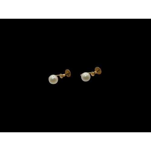 49 - Pair of screw-back pearl earrings, the yellow metal marked 9CT, gross weight 1.24 grams
