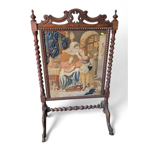 362 - Ornate oak fire screen with tapestry front. W72cm D52cm H117cm.