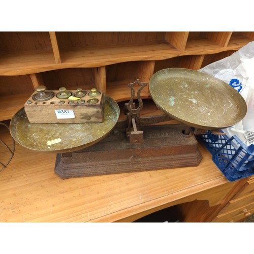 387 - Forged cast iron scales with brass weights. 50x23cm